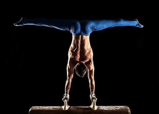 homme gymnaste en équilibre sur les mains sur un cheval-d'arçons - male body sport exercising photos et images de collection