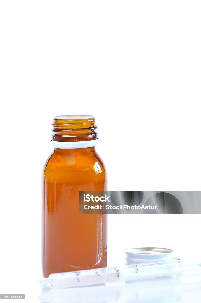 Syrup bottle with syringe. Syrup bottle with syringe on white background. 2015 Stock Photo