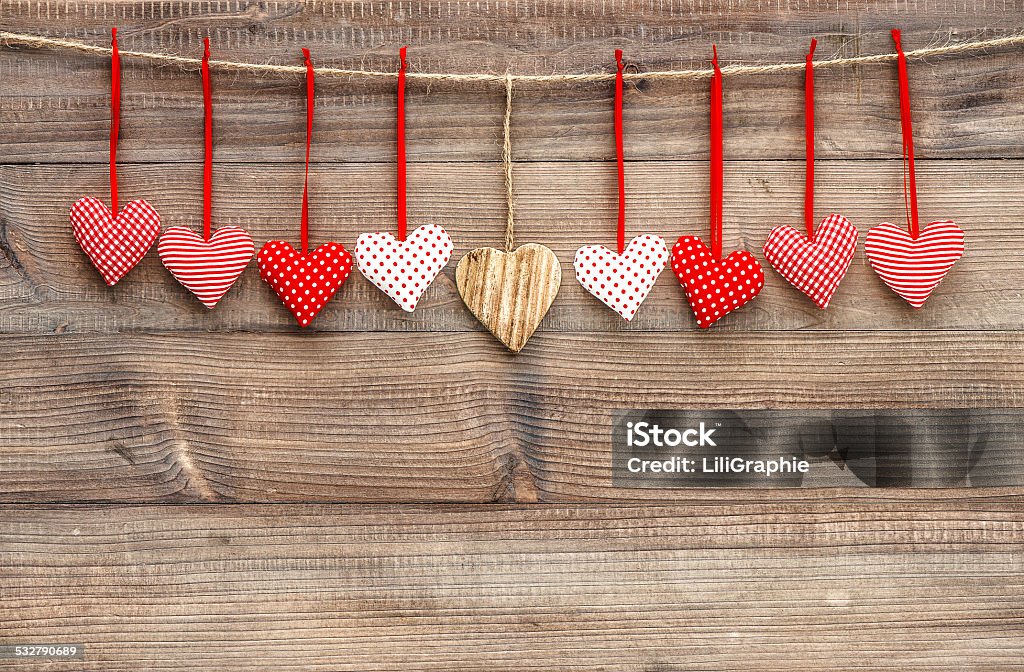Red hearts over wooden background. Valentines Day decoration Red hearts hanging over wooden background. Handmade Valentines Day decoration 2015 Stock Photo