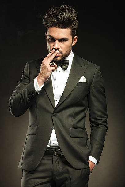 istock business man holding one hand in pocket while smoking 532791331