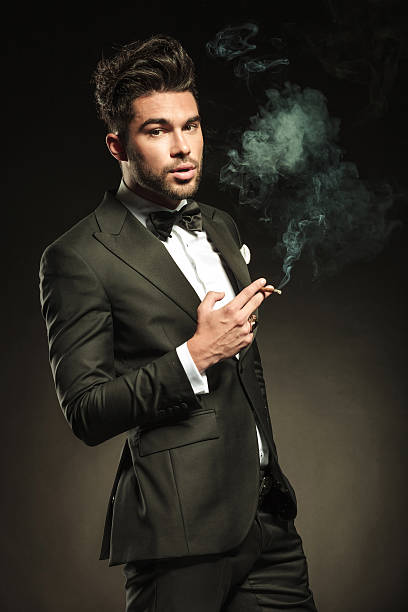 istock business man holding a cigarette in his right hand 532791337