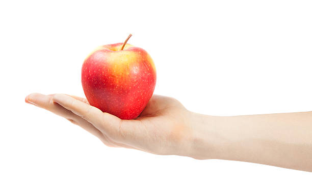 istock hand holding apple isolated on white background 532791359