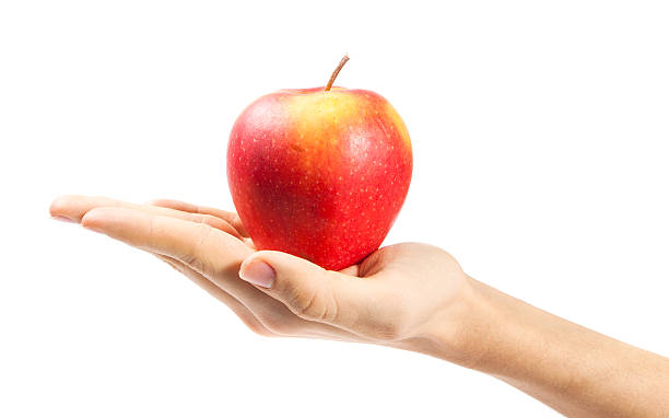 istock hand holding apple isolated on white background 532791365