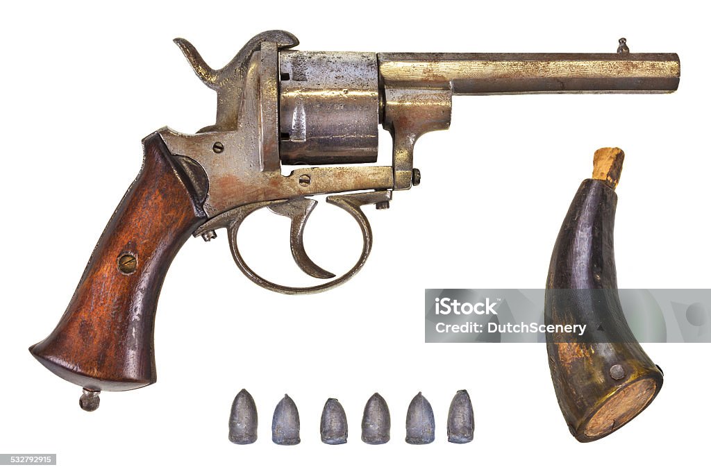 Revolver with bullets and gun powder Ancient revolver with six bullets and gun powder isolated on a white background 2015 Stock Photo