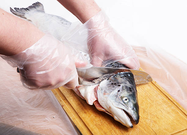 istock Cook cutting a salmon on wooden board 532812245