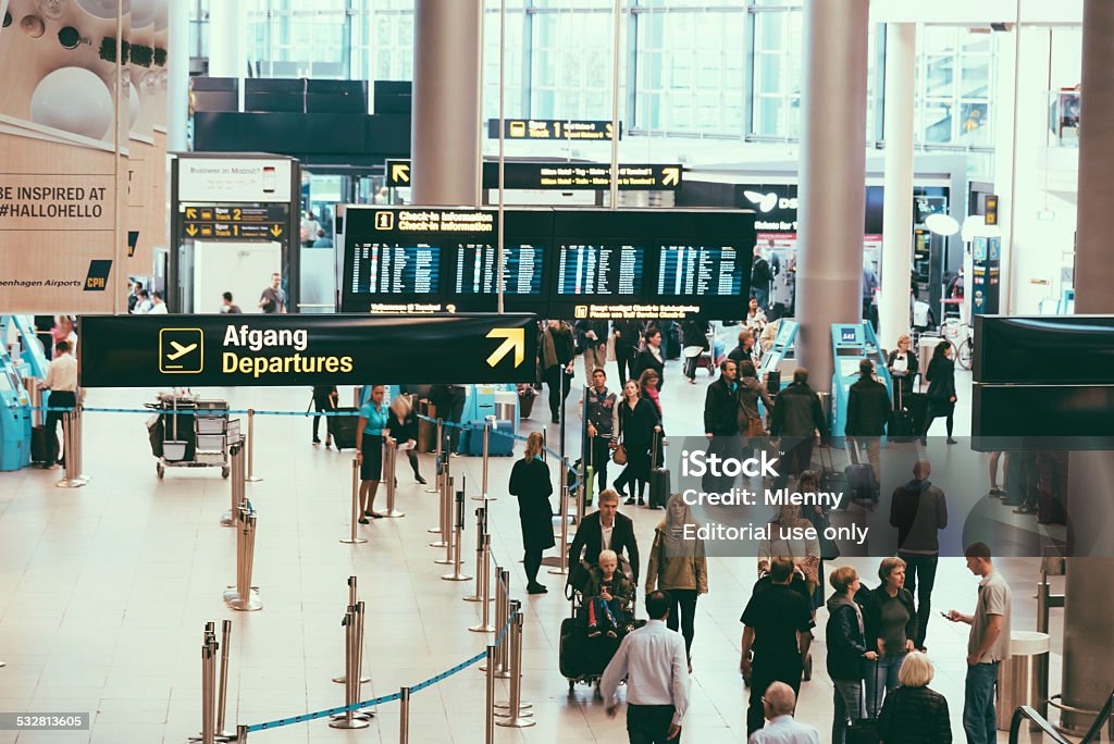 Copenhagen Airport CPH Departure Terminal Copenhagen, Denmark - September 14, 2014: People walking towards the check-in counters and airport gates in the departure hall of Copenhagen Airport (CPH), Denmark. Airport Stock Photo