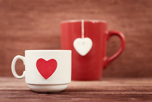 istock Cup with heart shapes over wooden background 532815393