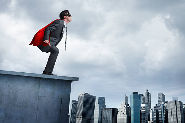 istock Superhero businessman in red cape attempting to take flight 532816503