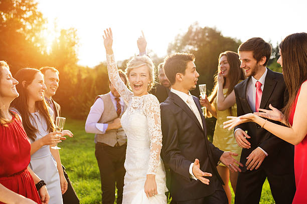 istock Newlyweds with guest on their garden party 532816607