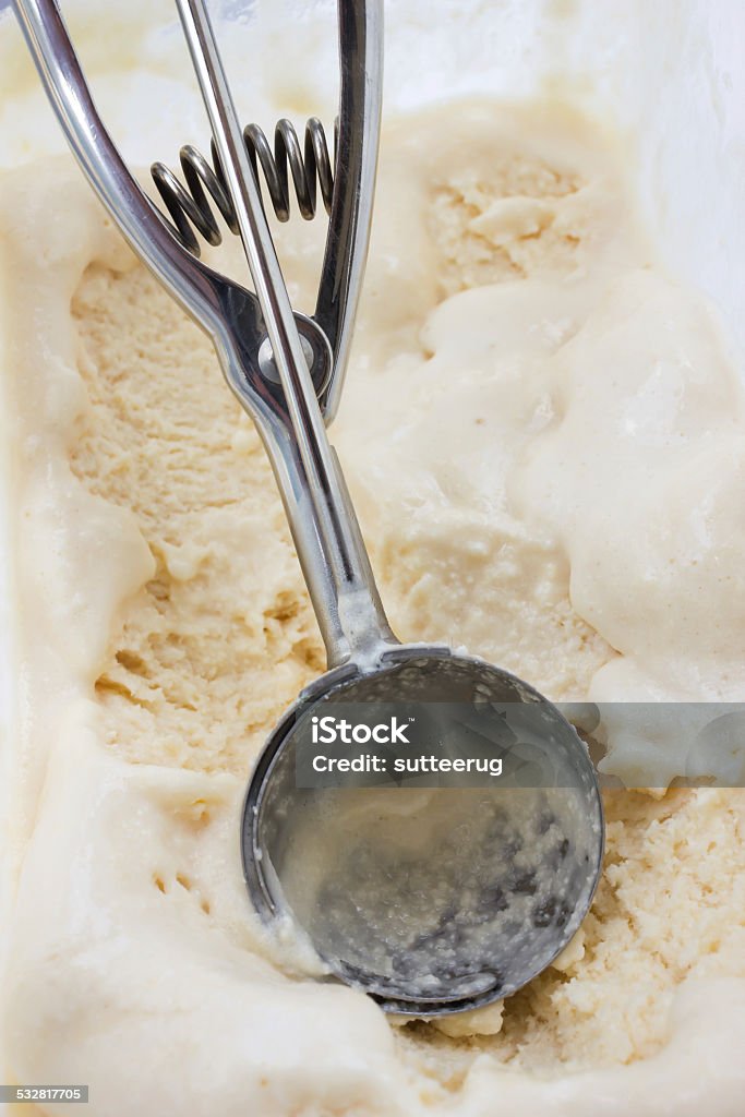 Scooper in lemon ice cream. Closeup lemon ice cream with scooper. 2015 Stock Photo