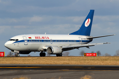 Prague, Сzech Republic - January 12, 2014: Belavia Boeing 737-5Q8 taxis to teminal at PRG Airport.