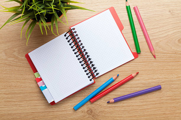 istock Office table with flower, blank notepad and colorful pencils 532835703