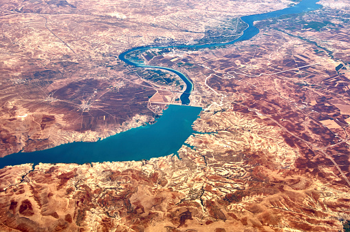 Aerial view about 9000 m height. Flying over the Birecik Dam and Birecik Dam Lake on Euphrates River, Turkey