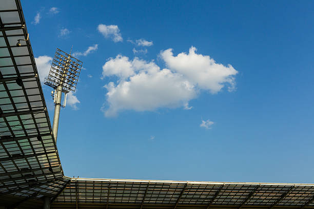 Stadium lights at dusk against a blue sky