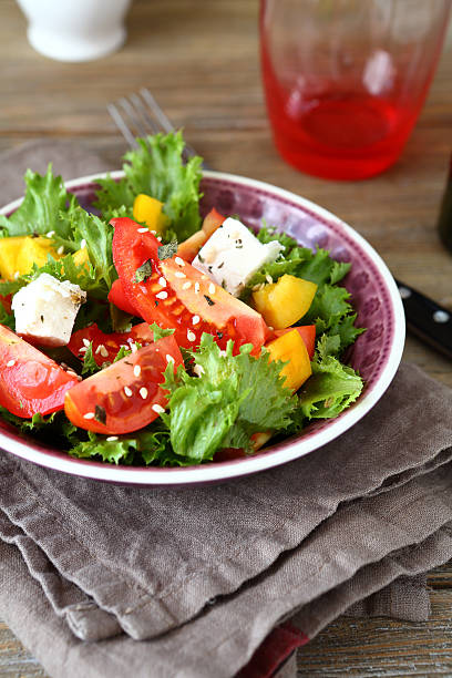 istock Salad with tomatoes, cheese and greens in a bowl 532837455