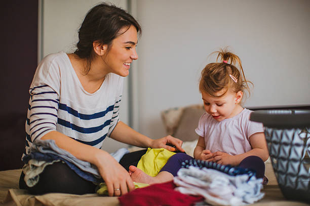 istock Mother and her daughter folding laundry together 532848790