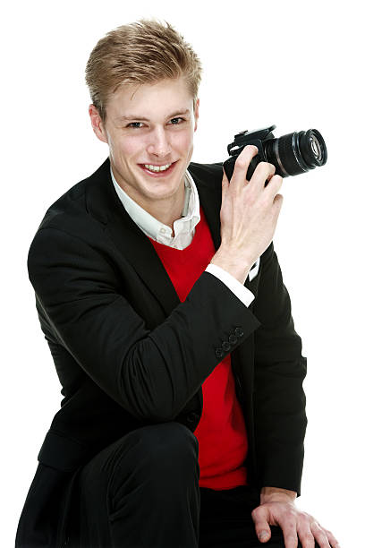 istock Smiling smart casual man holding camera 532849722