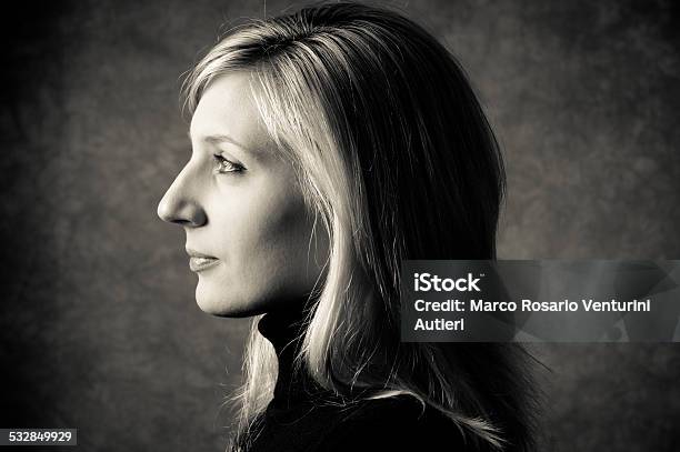Profile Of Woman In Studio Gray Background And Dramatic Light Stock Photo - Download Image Now