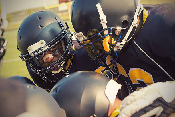 istock Football player talking with teammates in huddle before game 532849999