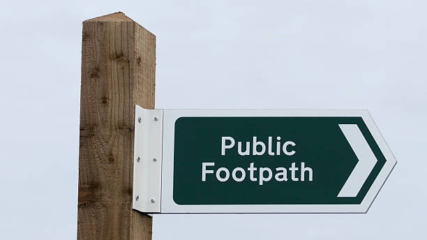 istock Public footpath sign on a wooden post in Devon field 532850088