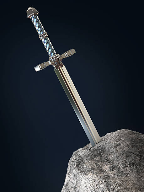 istock sword excalibur  King Arthur stuck in the rock stone isolated 532850188