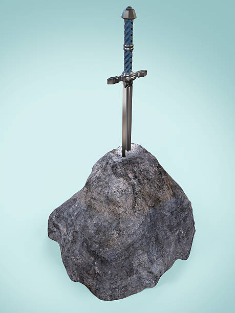 istock sword excalibur  King Arthur stuck in the rock stone isolated 532850336