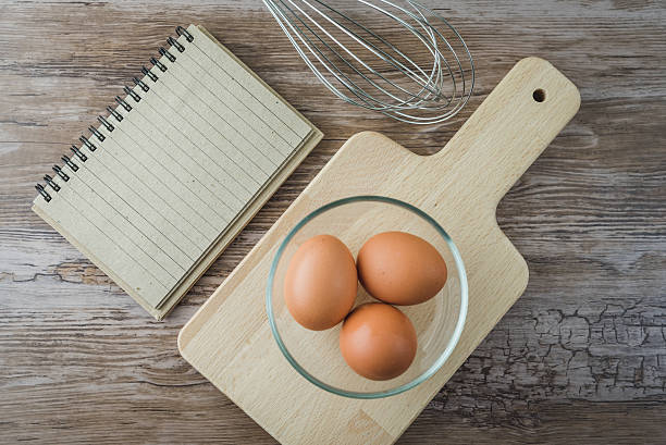 istock eggs in glass bowl and notepad on wooden rustic board 532850528