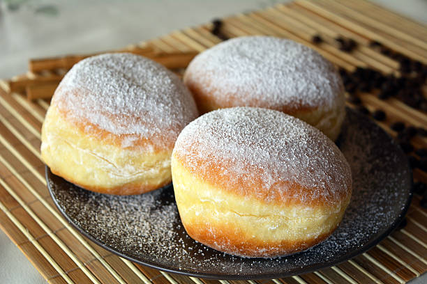 istock Donuts with powdered sugar on the brown plate on the table 532851341