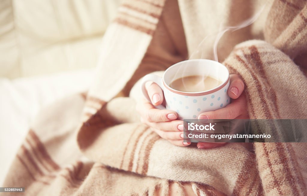 cup of hot coffee warming in the hands of girl warm cup of hot coffee warming in the hands of a girl Cold Temperature Stock Photo