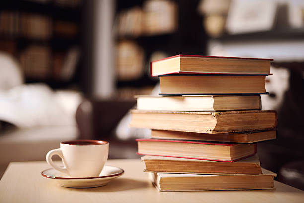 stack of books in home interior stock photo