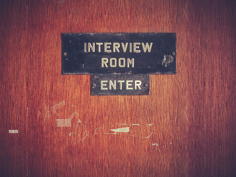 Retro Filtered Image Of A Grungy Interview Room Door
