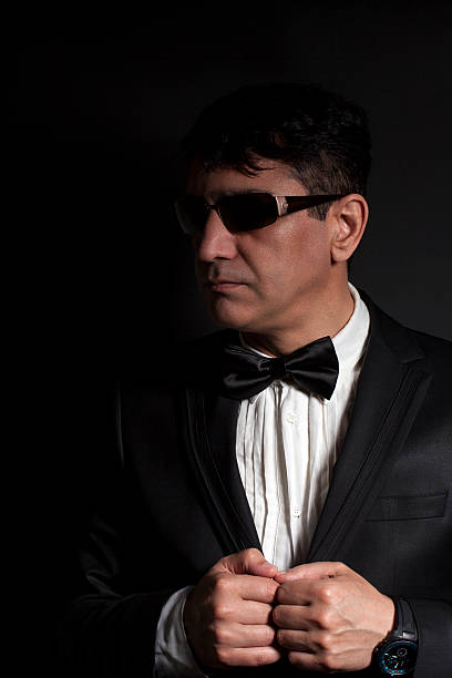 istock Business man in suit with sunglasses dresses butterfly 532853614