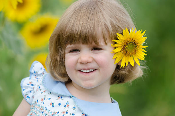 istock Little girl in a sunflower field 532855841