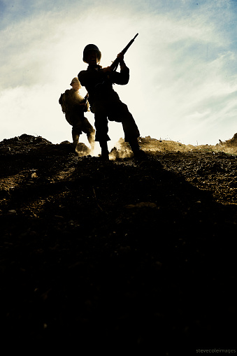 US Army Soldiers running on hill.