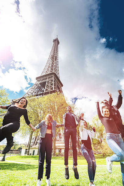 istock Group of people jumping on the park under tour eiffel 532855978