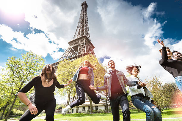 istock Group of people jumping on the park under tour eiffel 532856074