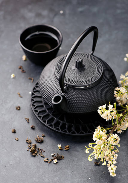 istock Green tea. Asian cast iron tea set, black background 532858904