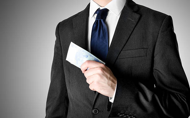 istock Businessman Dressed in Suit Holding Twenty Euro Bills 532859484