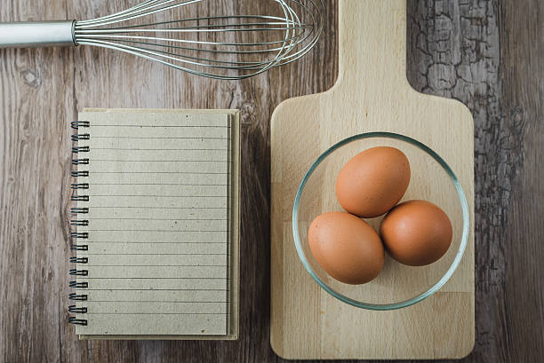 istock eggs in glass bowl and notepad on rustic wooden 532863694
