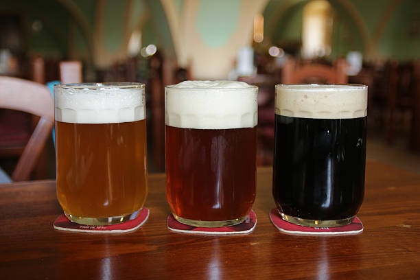 istock three glasses with different beers on wooden table 532864160