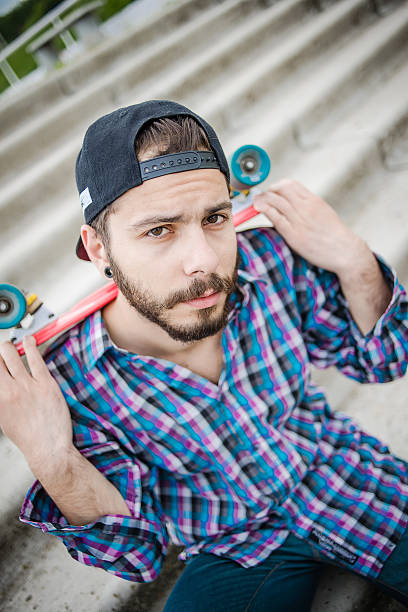 istock Stylish young guy on a red skateboard 532865850