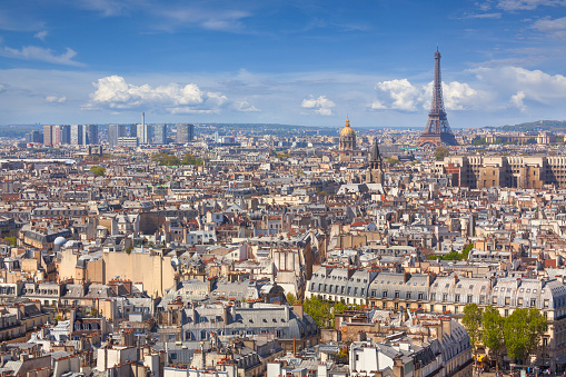 Daytime cityscape of central Paris, France, with the Eiffel tower in the distance.