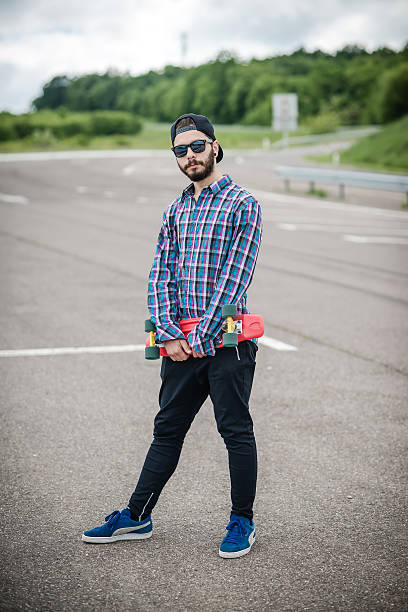 istock Stylish young guy on a red skateboard 532866160