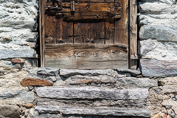istock stone wall texture with wooden door 532868168