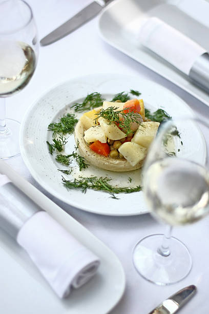 istock Artichoke and white wine on the dinner table. 532868582