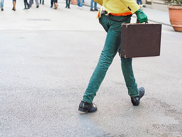 extravagant man walking with a briefcase stock photo