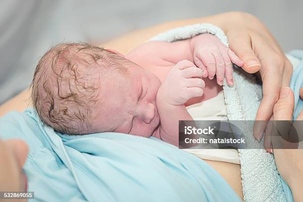 Young Beautiful Woman With A Newborn Stock Photo - Download Image Now - 2015, Adult, Bed - Furniture