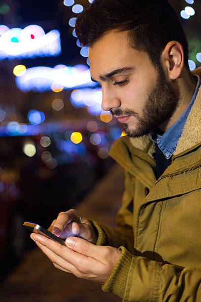 istock Portrait of young man using his mobile phone at night. 532869067
