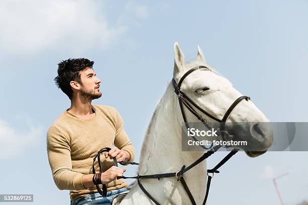 Young Man Riding A Horse Stock Photo - Download Image Now - Cowboy, Low Angle View, 2015