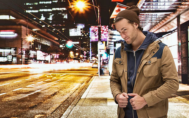 istock Smiling man out in the city at night 532869811